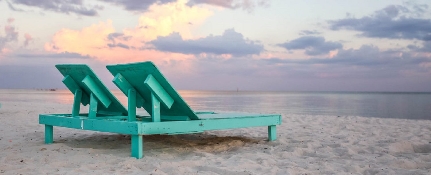 Beach chairs on a sunset beach