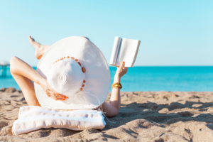 woman reading on beach