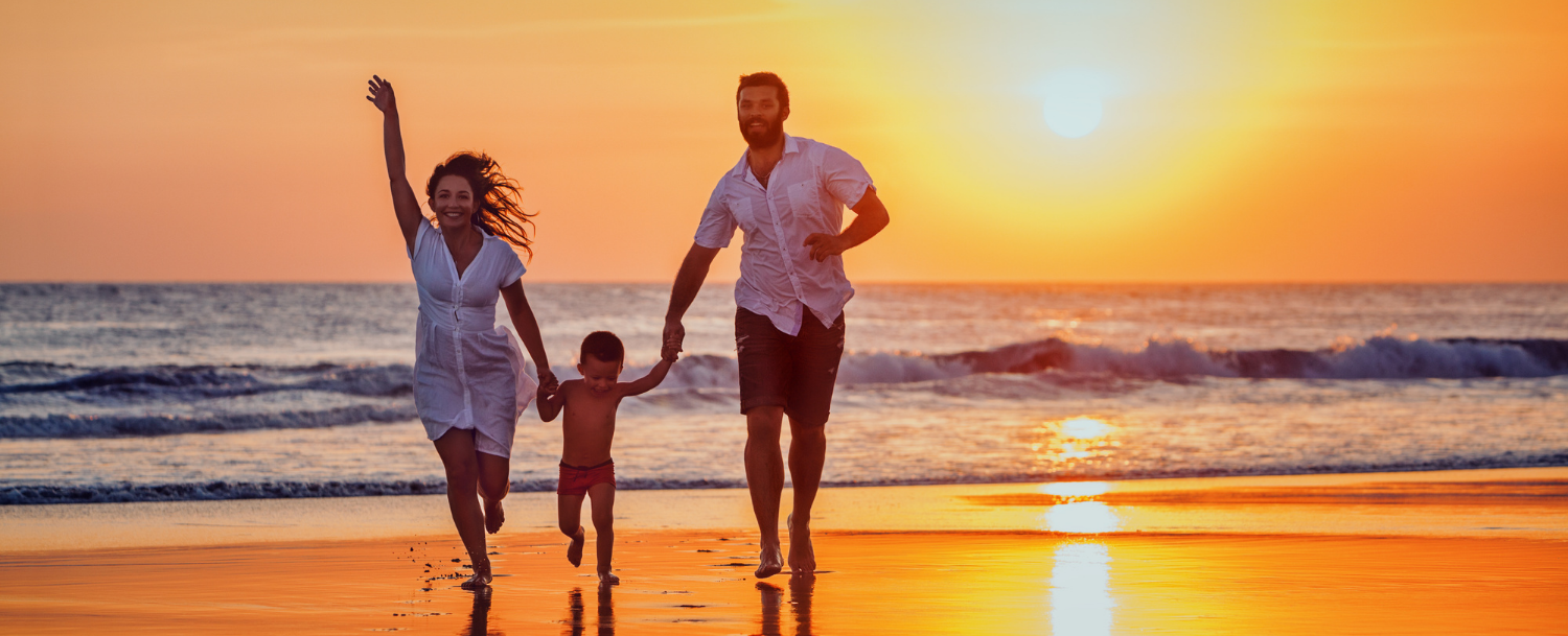 family on beach in sunset